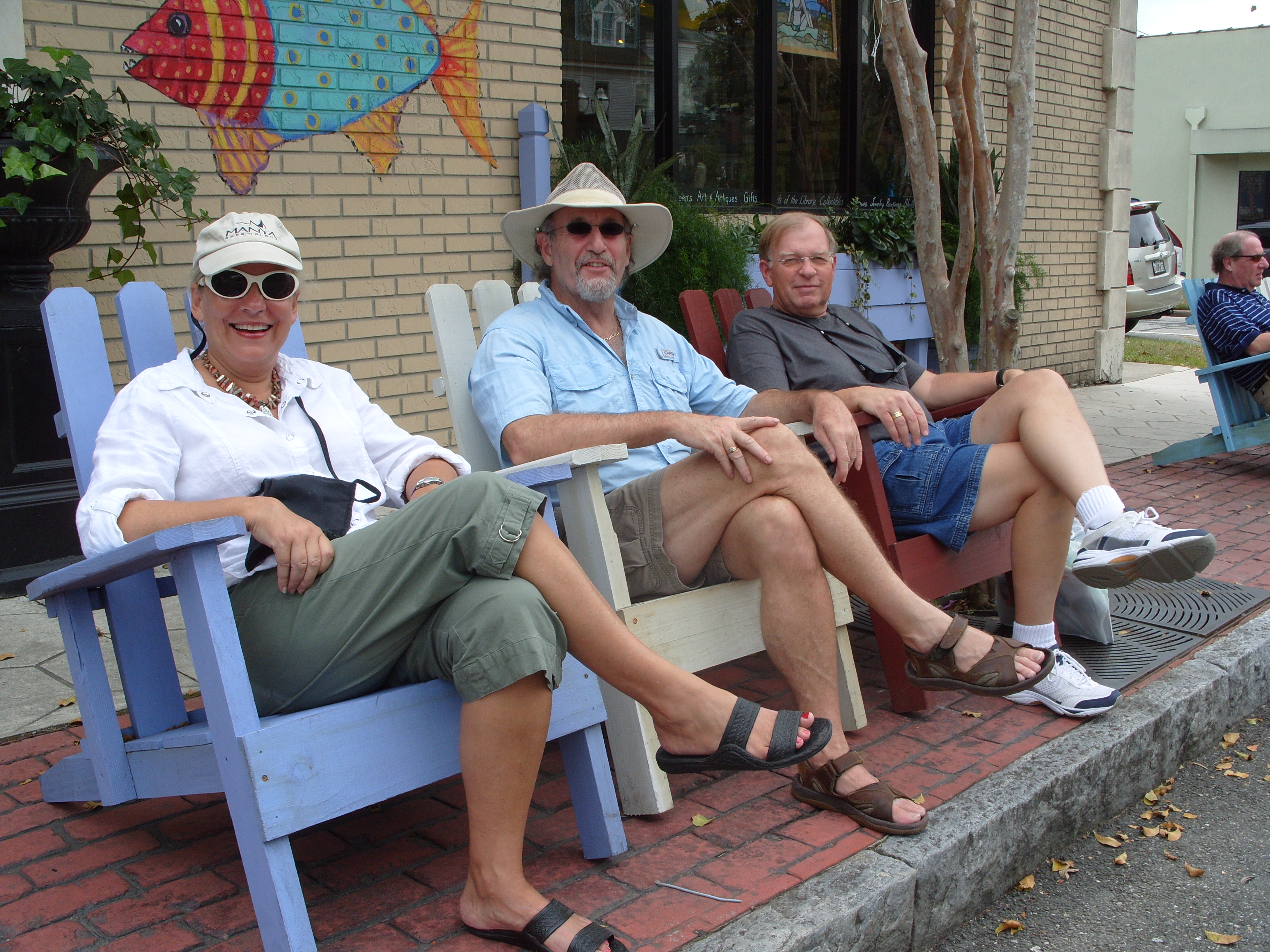 Guests relaxing in colorful Adirondack chairs on the streets of Fernandina Beach Amelia Island Florida